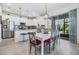 Bright dining area with modern table, with access to an outdoor patio and white kitchen at 5743 Skytop Dr, Lithia, FL 33547
