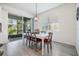 Bright dining area with large sliding glass doors and neutral decor and vinyl flooring at 5743 Skytop Dr, Lithia, FL 33547