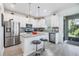 Modern kitchen with stainless steel appliances, a center island and ample counter space at 5743 Skytop Dr, Lithia, FL 33547