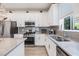 Modern kitchen featuring stainless steel appliances, gray subway tile backsplash, and light countertops at 5743 Skytop Dr, Lithia, FL 33547