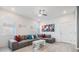 Bright living room featuring a gray sectional, white walls, modern décor and vinyl flooring at 5743 Skytop Dr, Lithia, FL 33547