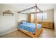 Cozy bedroom featuring a wooden four-poster canopy bed and ample closet space at 5925 Shore S Blvd # 611, Gulfport, FL 33707