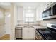 Bright kitchen featuring stainless steel appliances and granite countertops at 5925 Shore S Blvd # 611, Gulfport, FL 33707