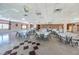 Spacious meeting room featuring neutral colors, tile floors, lots of tables, and disco ball to enhance community events at 5925 Shore S Blvd # 611, Gulfport, FL 33707