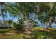 Beautiful Paradise Park with lush greenery, palm trees, a sign, and serene waterfront views at 5925 Shore S Blvd # 611, Gulfport, FL 33707