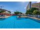 Community swimming pool surrounded by lounge chairs and lush greenery at 5925 Shore S Blvd # 611, Gulfport, FL 33707