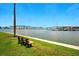 Scenic waterfront view featuring a bench, condos and docks under a clear blue sky at 5925 Shore S Blvd # 611, Gulfport, FL 33707