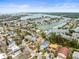 Aerial view of neighborhood featuring waterfront homes with boat docks on canals leading to the open bay at 619 2Nd St # 3, Indian Rocks Beach, FL 33785