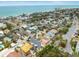 Aerial view showcases colorful beachside community with mature trees and proximity to the ocean at 619 2Nd St # 3, Indian Rocks Beach, FL 33785