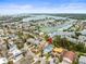 Wide aerial view of coastal neighborhood, showcasing waterfront homes, waterways, and lush greenery at 619 2Nd St # 3, Indian Rocks Beach, FL 33785