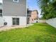 Backyard with well-kept lawn, privacy fence, sliding glass door and patio at 619 2Nd St # 3, Indian Rocks Beach, FL 33785