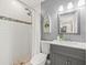 Tastefully designed bathroom with a vanity, shower, and unique boat-shaped shelving unit, enhancing the room's nautical theme at 619 2Nd St # 3, Indian Rocks Beach, FL 33785