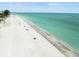 Wide angle aerial shot of sandy beach and crystal clear ocean waters on a sunny day at 619 2Nd St # 3, Indian Rocks Beach, FL 33785