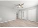 Bright bedroom with neutral walls, light wood floors, ceiling fan and closet doors at 619 2Nd St # 3, Indian Rocks Beach, FL 33785