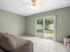 Bonus room featuring tile flooring, ceiling fan, comfortable couches and sliding glass doors to backyard at 619 2Nd St # 3, Indian Rocks Beach, FL 33785