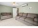 Bonus room featuring tile flooring, ceiling fan, comfortable couches and access door at 619 2Nd St # 3, Indian Rocks Beach, FL 33785
