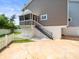 Home exterior with stairs to a screened porch, offering an outdoor living space and access to the backyard at 619 2Nd St # 3, Indian Rocks Beach, FL 33785