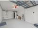 Garage featuring overhead door mechanism, painted walls, and concrete floor at 619 2Nd St # 3, Indian Rocks Beach, FL 33785