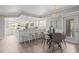 Modern kitchen with white cabinets, stainless steel appliances, and a breakfast bar overlooking the dining area at 619 2Nd St # 3, Indian Rocks Beach, FL 33785