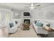 Comfortable living room with a stone fireplace, ceiling fan, and glass doors to the outside at 619 2Nd St # 3, Indian Rocks Beach, FL 33785