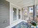 Cozy porch with double doors, stylish seating, and lush tropical accents create a serene outdoor retreat at 619 2Nd St # 3, Indian Rocks Beach, FL 33785