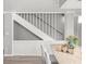 View of staircase near the kitchen with granite countertop and flower decoration at 619 2Nd St # 3, Indian Rocks Beach, FL 33785