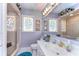 Bathroom featuring a large mirror, marble countertop and a shower with decorative glass at 6612 N Orleans Ave, Tampa, FL 33604