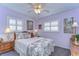 Well decorated bedroom with chandelier, two side tables and two windows with shutters at 6612 N Orleans Ave, Tampa, FL 33604