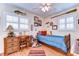 bedroom with wood floors, themed decor and window with shutters at 6612 N Orleans Ave, Tampa, FL 33604