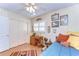 bedroom with wood floors, themed decor, closet and a window with shutters at 6612 N Orleans Ave, Tampa, FL 33604