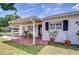 Welcoming front porch with brick flooring, bench seating, and shade from the covered carport at 6612 N Orleans Ave, Tampa, FL 33604