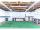 Bright garage with exposed rafters, workbench, white cabinets, painted floor, and ample storage at 6612 N Orleans Ave, Tampa, FL 33604