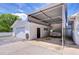 Attached garage with covered carport area and a vintage car providing secure parking at 6612 N Orleans Ave, Tampa, FL 33604