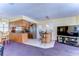 Spacious living room featuring a kitchen with stainless steel appliances, island and bar seating at 6612 N Orleans Ave, Tampa, FL 33604