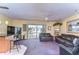 Spacious living room with sliding glass doors, ceiling fan, bar with seating and modern decor at 6612 N Orleans Ave, Tampa, FL 33604