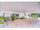 Covered patio with ample seating, greenery, and sliding glass doors for indoor-outdoor living at 6612 N Orleans Ave, Tampa, FL 33604