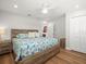 Bright bedroom featuring a wooden bed frame, ceiling fan, and an ensuite closet for ample storage at 75 Lido Dr, St Pete Beach, FL 33706