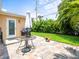 Cozy patio featuring stylish brick pavers, lush greenery, and outdoor seating ideal for relaxation at 75 Lido Dr, St Pete Beach, FL 33706