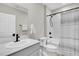 Bright bathroom features a modern vanity with sleek black fixtures, toilet, and tub with decorative shower curtain at 7721 Twin Leaf Ter, Parrish, FL 34219