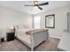 Comfortable bedroom with large windows, ceiling fan, plush carpet, and neutral tones at 7721 Twin Leaf Ter, Parrish, FL 34219