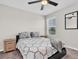 Cozy bedroom with a ceiling fan, plush carpet, and large windows for natural light at 7721 Twin Leaf Ter, Parrish, FL 34219