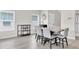 Dining area with modern table, six chairs, beverage cooler, and ample natural light at 7721 Twin Leaf Ter, Parrish, FL 34219