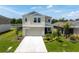 Charming two-story home showcasing well-maintained landscaping and a spacious driveway at 7721 Twin Leaf Ter, Parrish, FL 34219