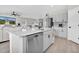 Bright kitchen featuring stainless steel appliances, white cabinets, and an island with sink at 7721 Twin Leaf Ter, Parrish, FL 34219