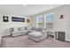 Comfortable living room with a gray sectional sofa and carpeted floor at 7721 Twin Leaf Ter, Parrish, FL 34219