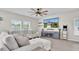 Bright living room with large windows and stylish sectional sofa at 7721 Twin Leaf Ter, Parrish, FL 34219
