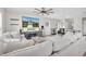 Open living room with large sectional sofa, entertainment center, and ceiling fan at 7721 Twin Leaf Ter, Parrish, FL 34219