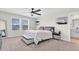 Cozy main bedroom featuring a large bed, bench, and carpeted floor at 7721 Twin Leaf Ter, Parrish, FL 34219