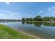 Scenic view of a tranquil pond surrounded by lush greenery, reflecting a serene and peaceful atmosphere at 7721 Twin Leaf Ter, Parrish, FL 34219