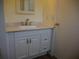 Bathroom vanity features white cabinets, marble-look countertop, and a modern sink faucet at 8255 Richmond St, Gibsonton, FL 33534